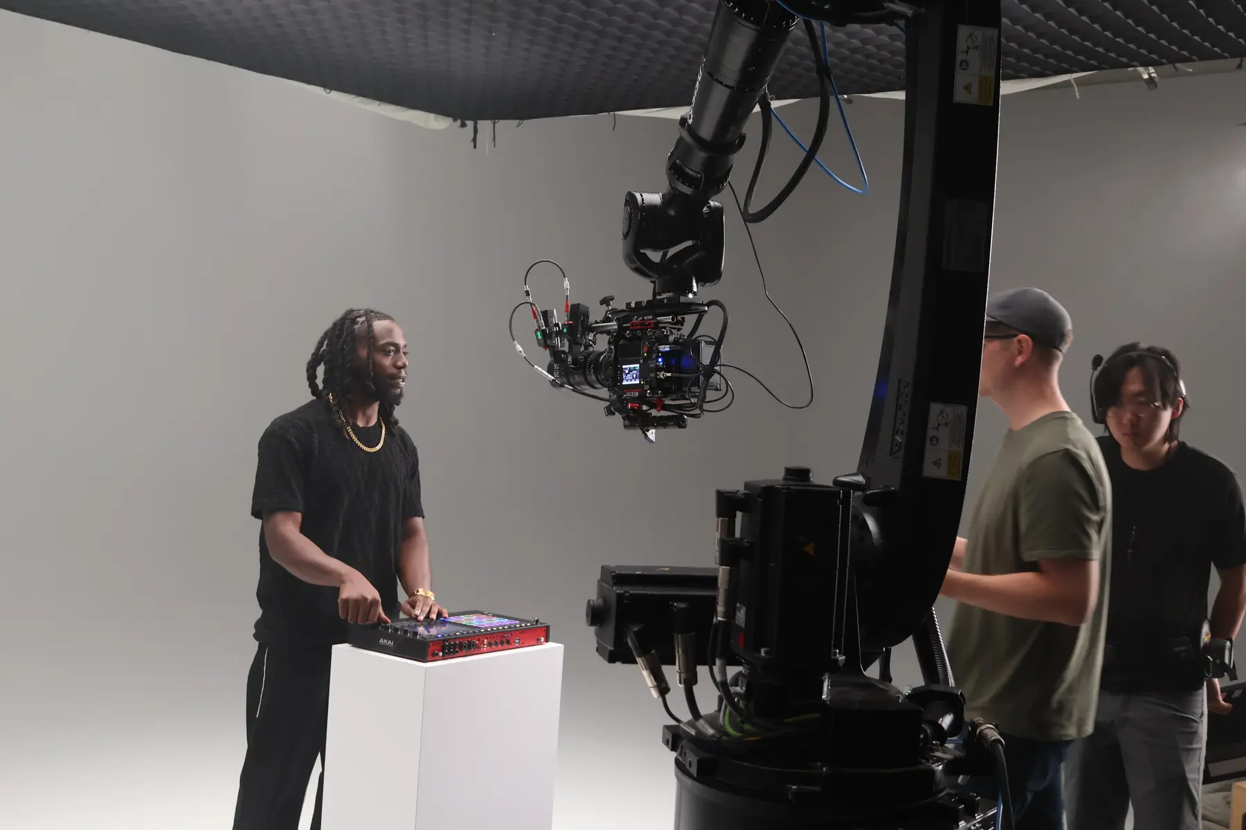 Crew operating cinema robot with talent on set