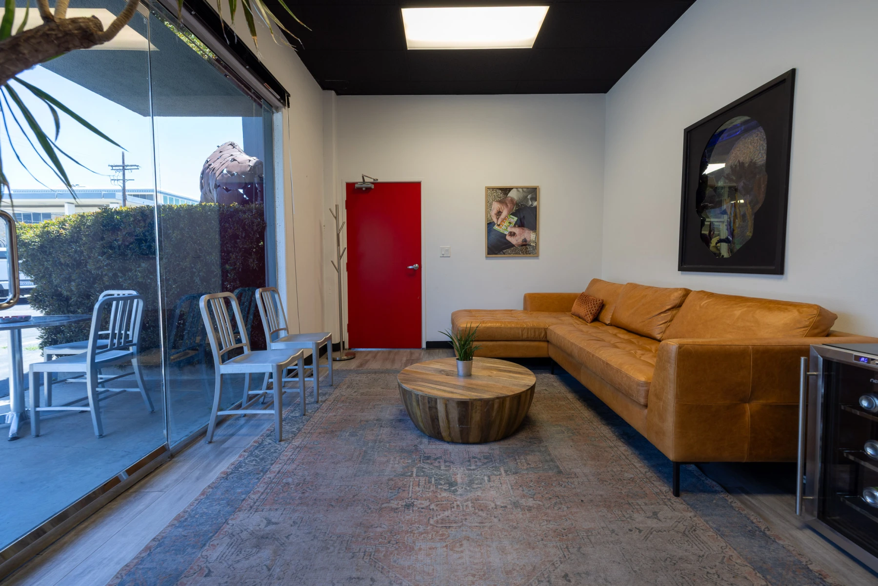 Client green room with leather sofa and art